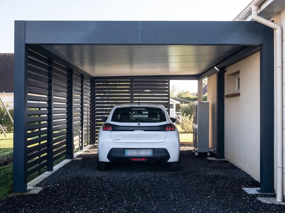 Carport métallique moderne abritant une Peugeot 308 blanche